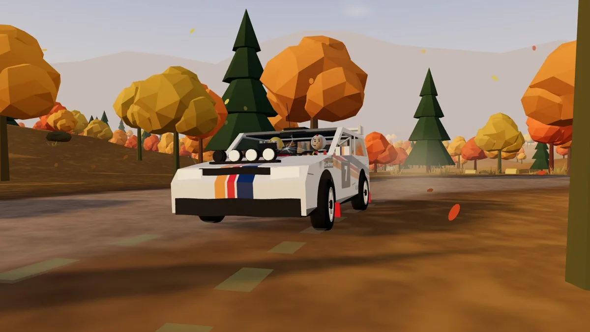 A white rally car with two helmeted crew members on a road lined with orange autumn trees in Flat Over Crest.